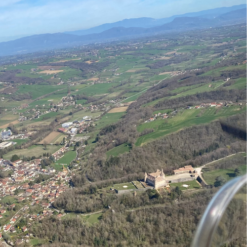 Vol en ULM au-dessus des collines dauphinoises, avec vue sur un chateau.